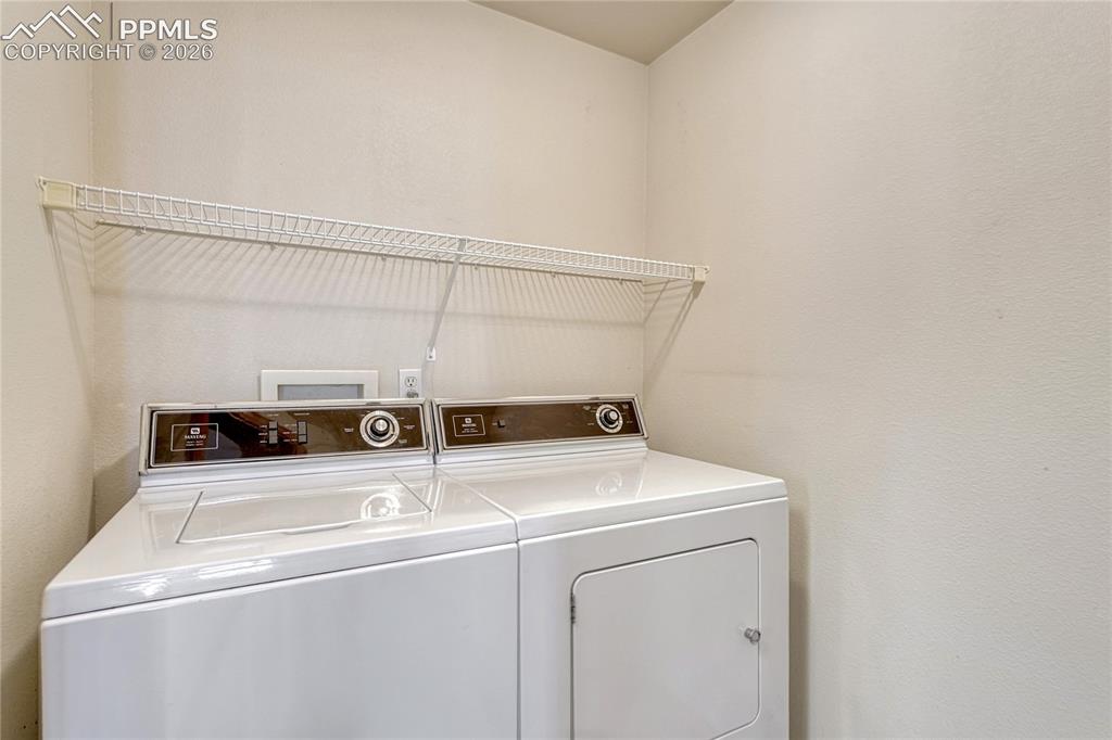 Image 16 of 48: Tucked conveniently near the kitchen is a dedicated laundry space equipped 