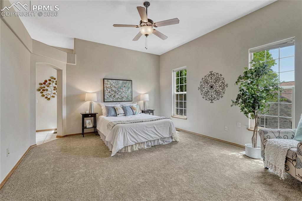 Image 20 of 48: This primary suite offers plenty of room for a king-sized bed and includes 