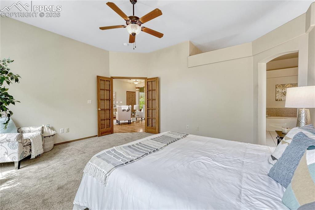 Image 21 of 48: High ceilings and tall windows make the primary suite a great space to star