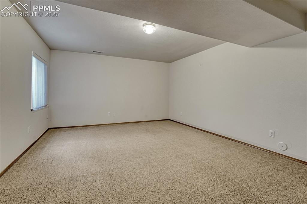 Image 31 of 48: This expansive lower-level bedroom offers limitless potential to fit your l