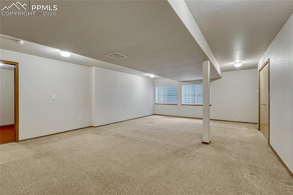 Image 34 of 48: The full basement bathroom is conveniently located near the bedrooms and fe