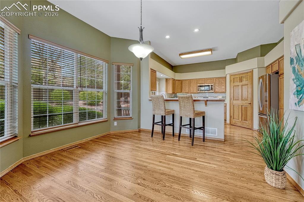 Image 7 of 48: The elegant hardwood floors run seamlessly through the main level. Notice t