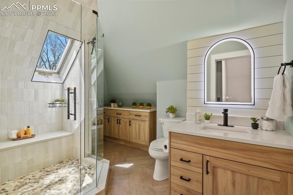 Image 31 of 40: Newly added spa-like 3/4 bathroom with beautiful floors, tile surround, roc