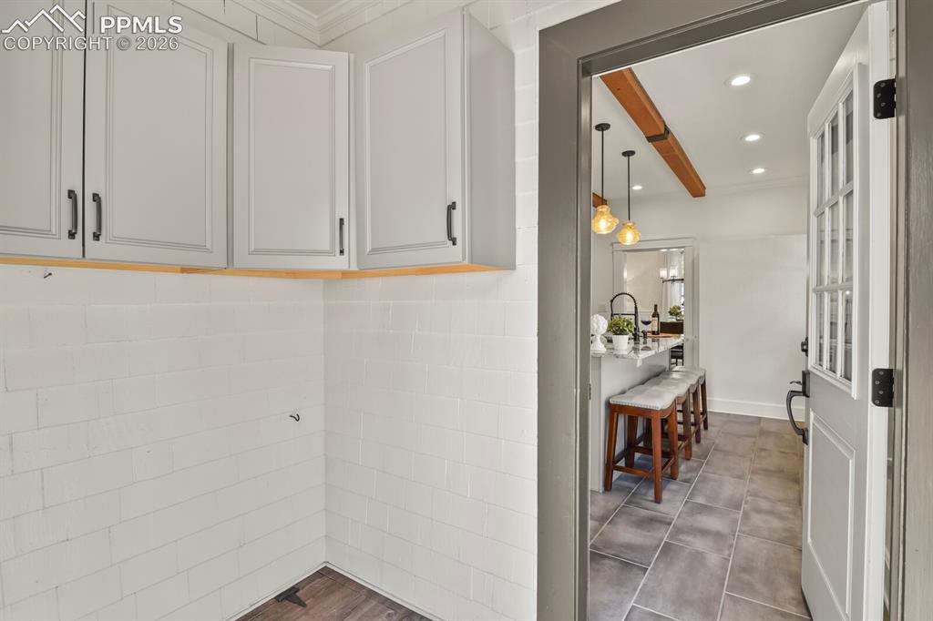 Image 33 of 40: Back enclosed porch- could be mudroom and has access to basement 