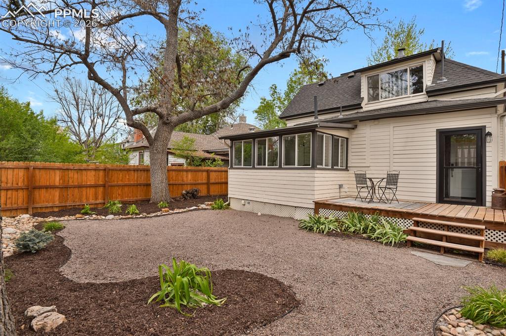Image 36 of 40: Beatiful backyard with landscaping and wood deck 