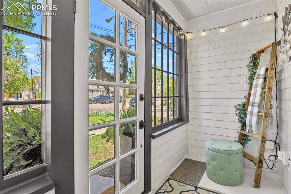 Image 6 of 40: Front entry- enclosed porch! 
