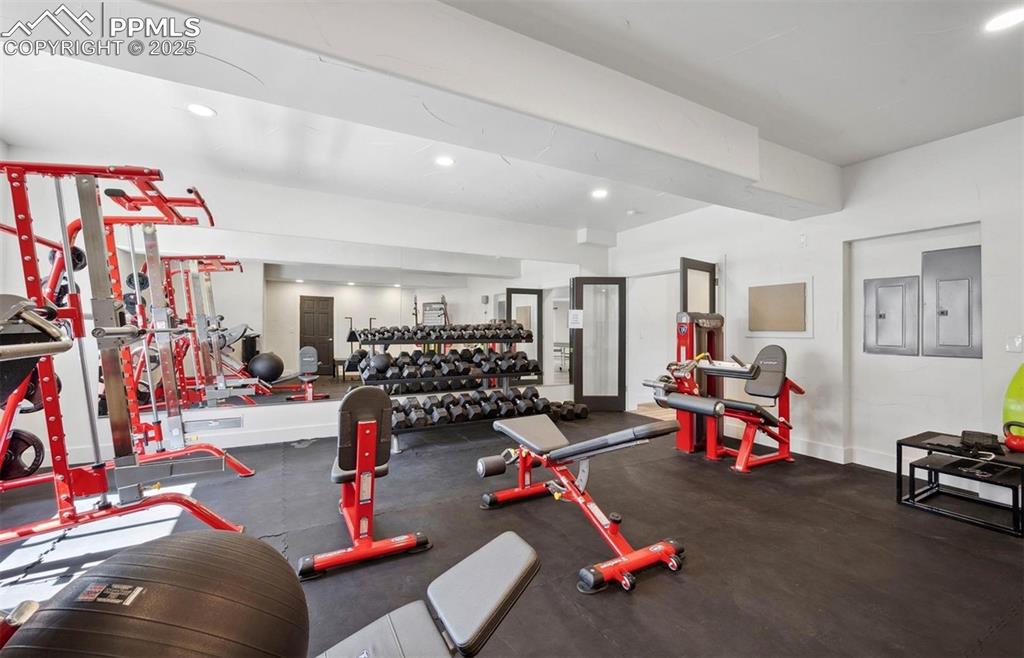 Image 12 of 31: Workout area featuring electric panel and recessed lighting