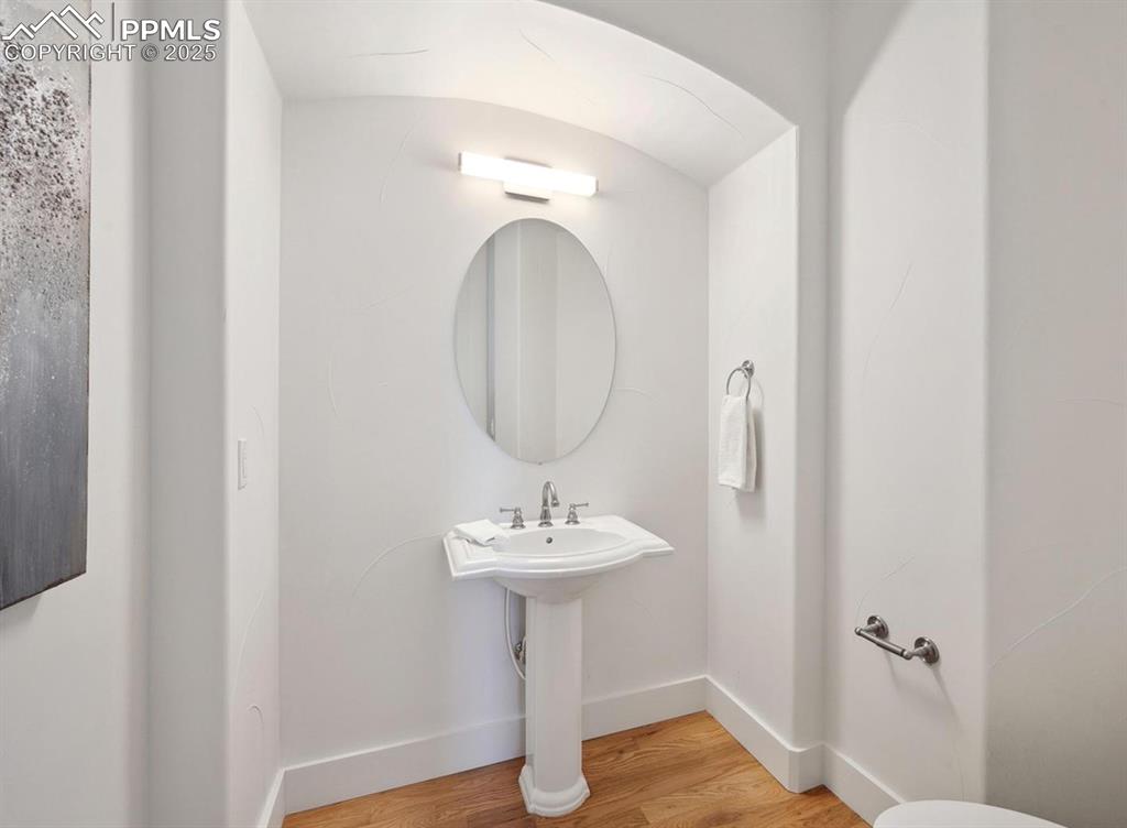 Image 18 of 31: Bathroom featuring light wood-style floors and baseboards