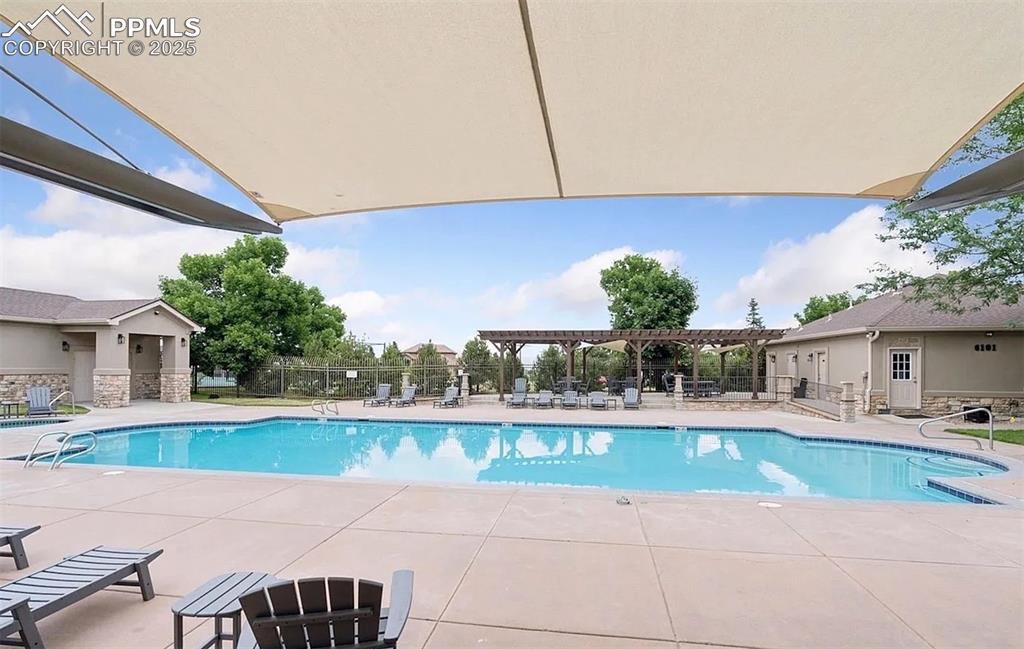 Image 26 of 31: Community pool featuring a patio and a pergola