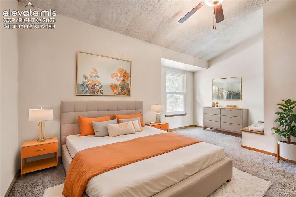 Image 15 of 35: Virtually Staged - Spacious room featuring a textured ceiling, a ceiling fa