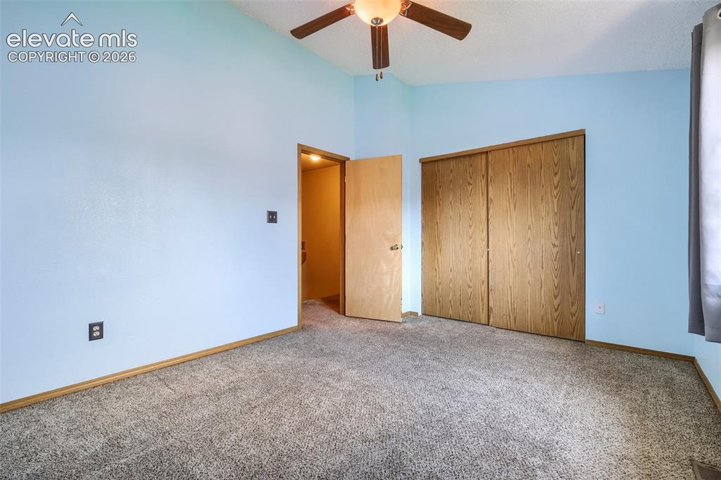 Image 25 of 35: Textured carpeting with wood-finish baseboards