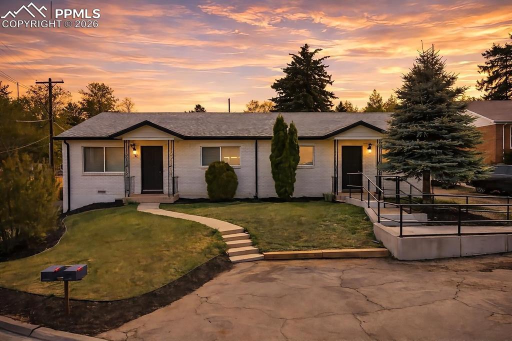 Caption: The property features two distinct entrances, each with a covered porch and exterior lighting