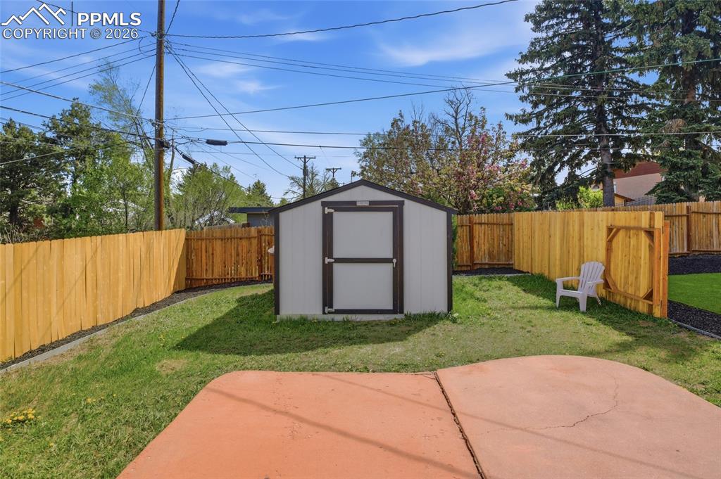 Image 34 of 44: The property features a private backyard with a storage shed, a wooden priv