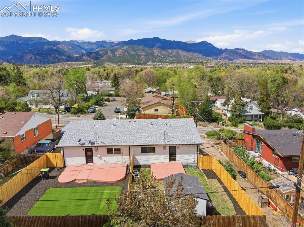Image 36 of 44: This property features a private yard with a patio and a section of artific