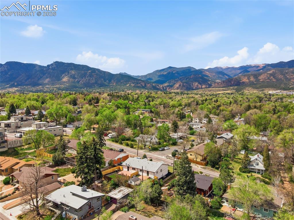 Image 42 of 44: An aerial view showcasing a residential area with a verdant landscape, surr