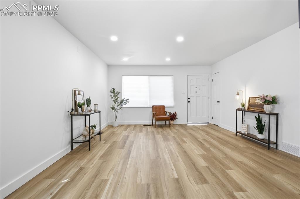 Image 7 of 44: The property features light-toned flooring, white walls, and recessed light