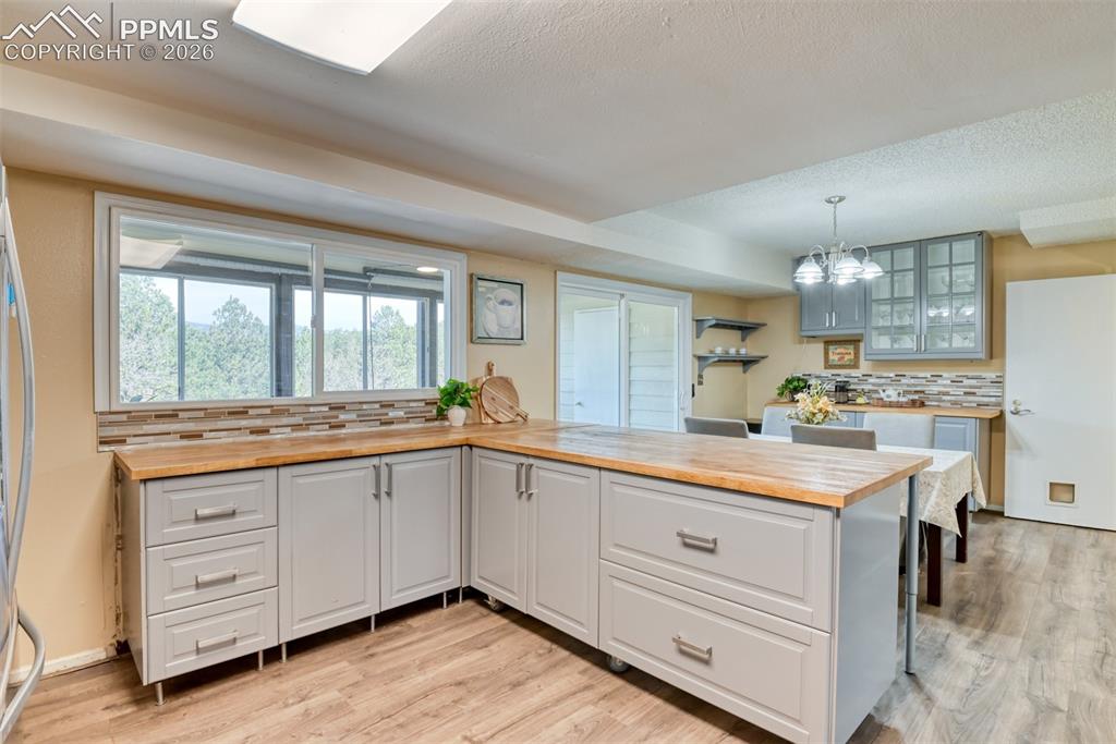 Image 11 of 38: Wonderful prep space...windows over look the enclosed deck. See door to the