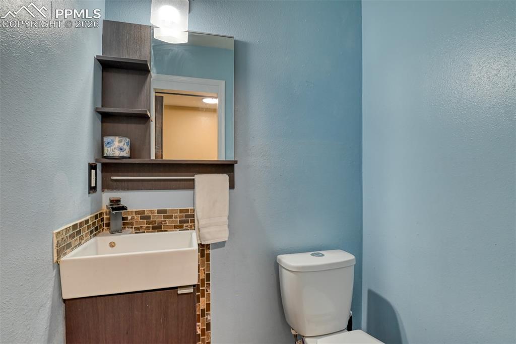 Image 18 of 38: Main level hall bathroom.