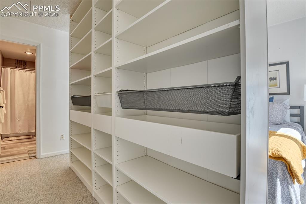 Image 22 of 38: Ikea walk thru closet provides plenty of space for clothes.