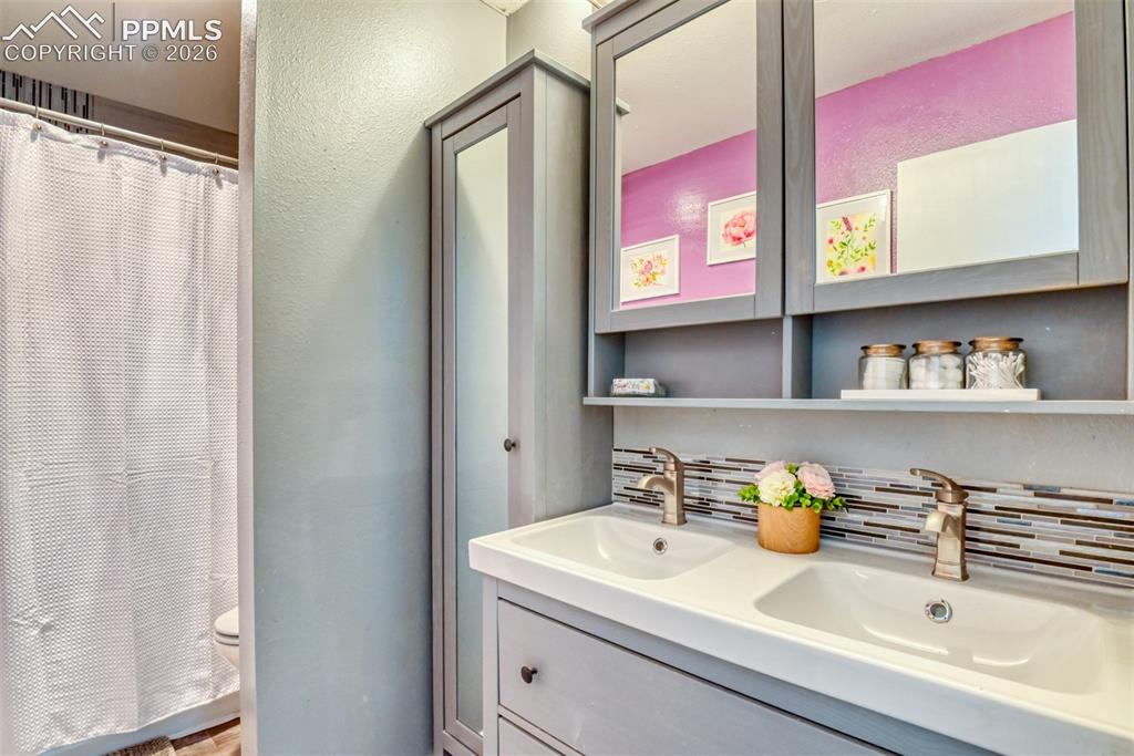 Image 23 of 38: Full bathroom connects to primary bedroom has double sinks and good storage