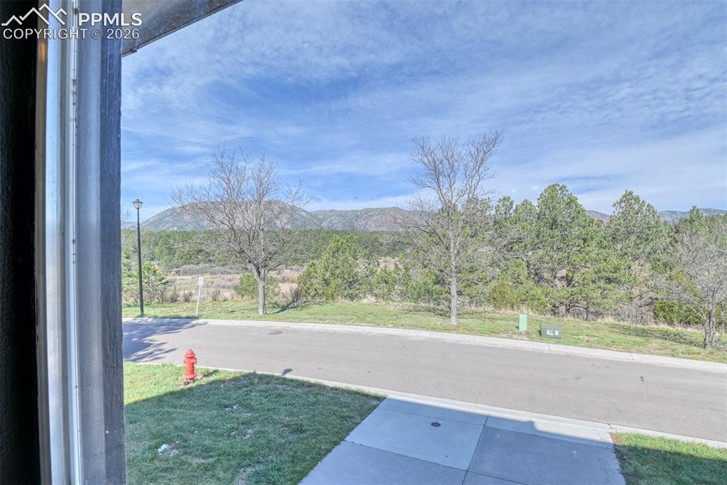 Image 3 of 38: View of the mountain and private bird sanctuary from the enclosed deck. 