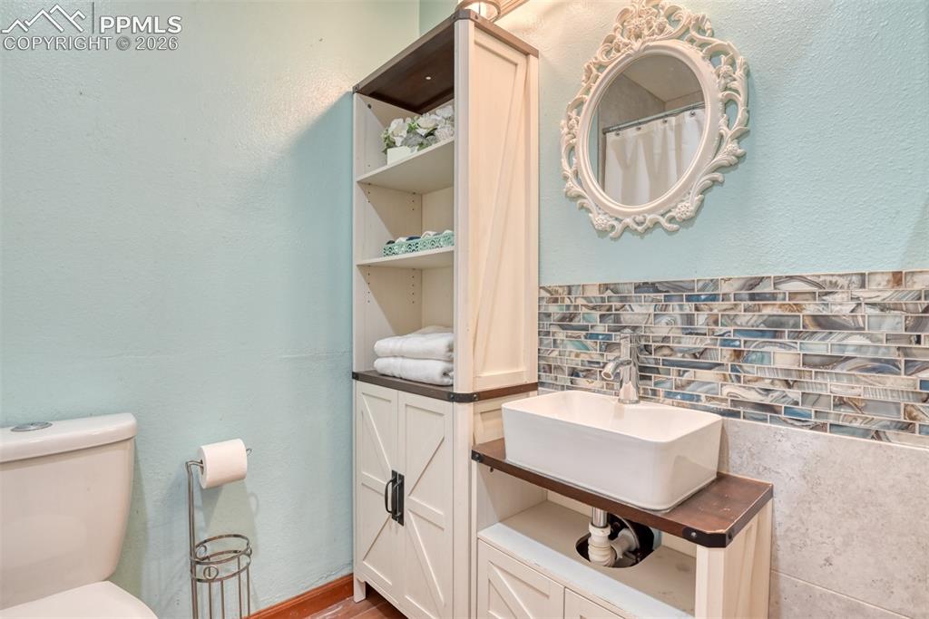Image 33 of 38: Upstairs full bathoom has linen closet right outside the door