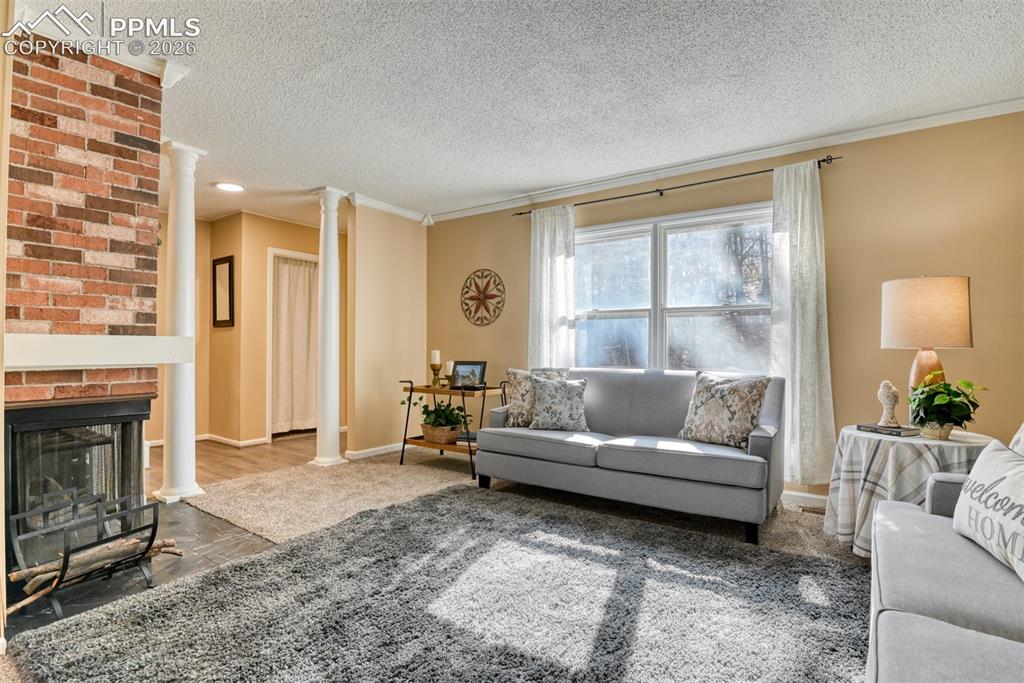 Image 7 of 38: Another view of the living room showing LVP in the entry and coat closet ju