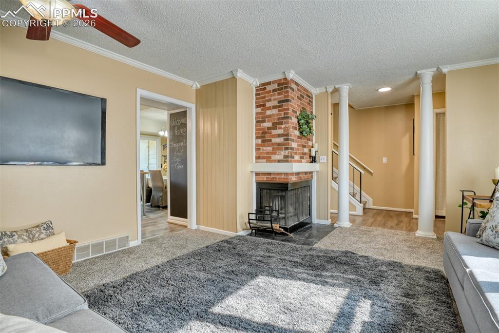 Image 8 of 38: See staircase in the background heading upstairs to the four bedrooms. 
