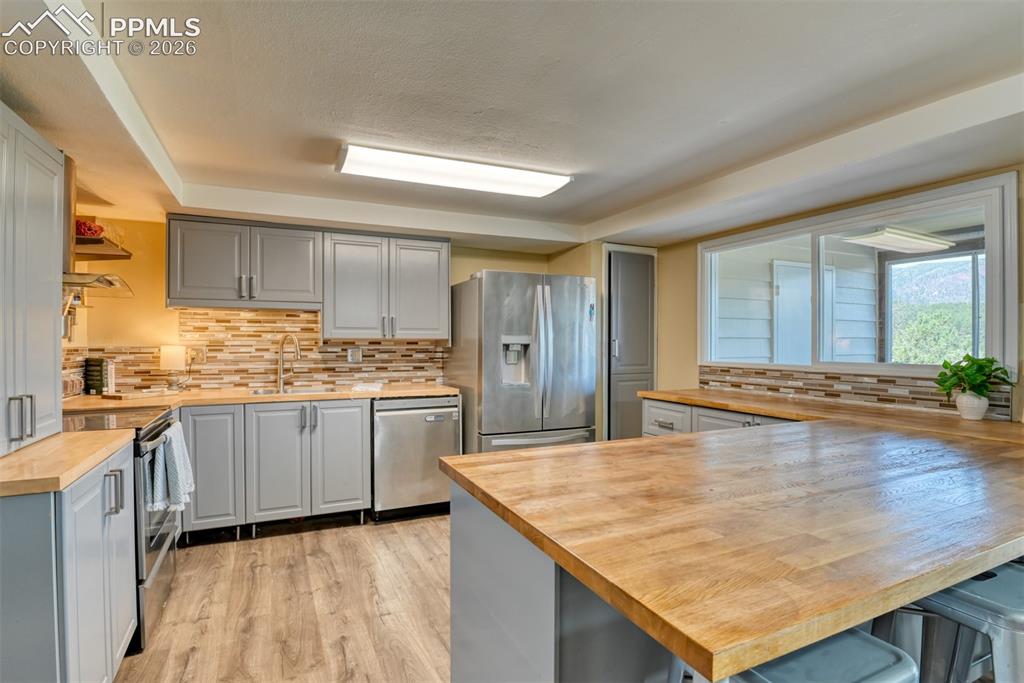 Image 9 of 38: Kitchen has been updated with new flooring, cabinets, stainless steel appli