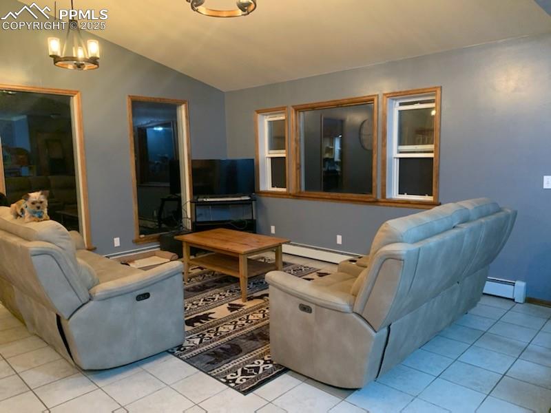 Image 11 of 28: Living room on the main level. Tons of windows.
