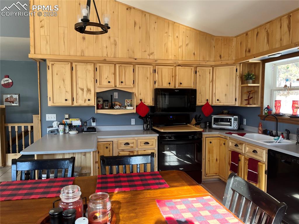 Image 12 of 28: Rustic kitchen. Newer appliance in the kitchen. Just the right amount o