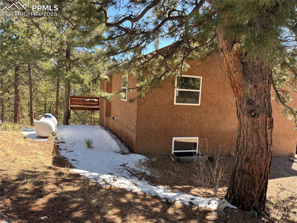 Image 5 of 28: Back of this lovely ranch style home. There is a second deck off the kitch
