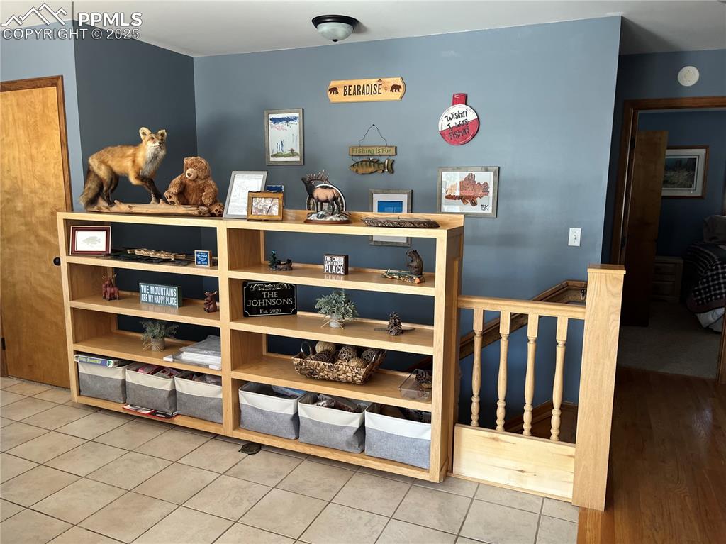 Image 7 of 28: On the upper entrance there is a tiled entry with closet and shelving.