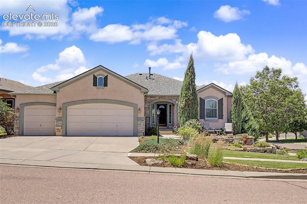 Image 1 of 31: Stucco and stone exterior with a 3 car garage.