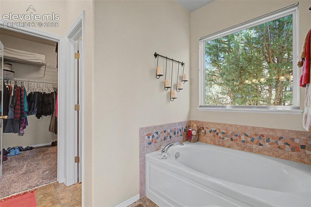Image 13 of 31: Soaking tub with garden view.