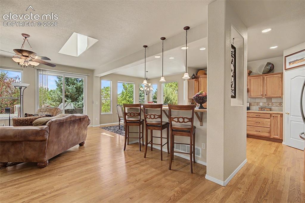 Image 3 of 31: Great room view, as you enter from the front door. Enjoy the hardwood floor