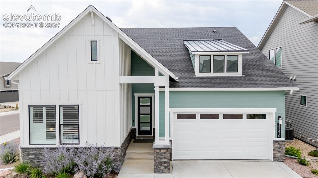 Caption: Modern farmhouse exterior featuring vertical board and batten siding, horizontal siding, and a promi