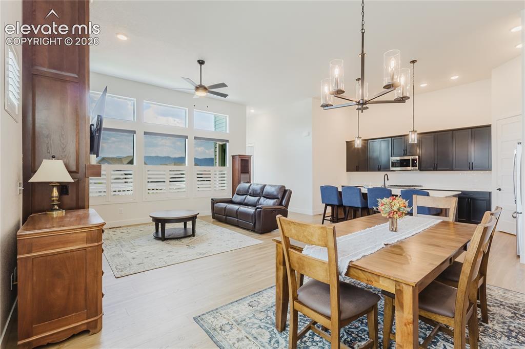 Image 14 of 46: Open-concept living area with a kitchen island, sink, stainless steel appli