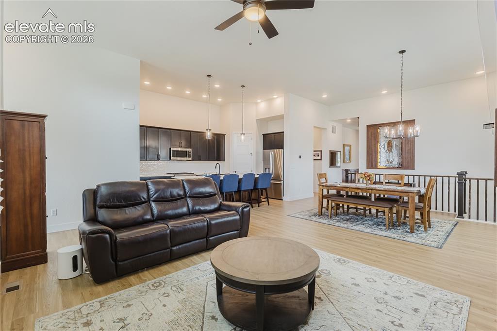 Image 15 of 46: Great room with plantation shutters, custom desiged and built hardwood abov