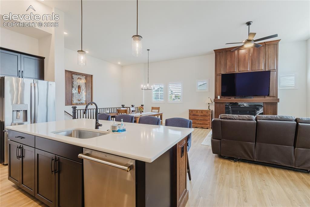 Image 18 of 46: High ceilings featuring a ceiling fan, a fireplace with custim designed and