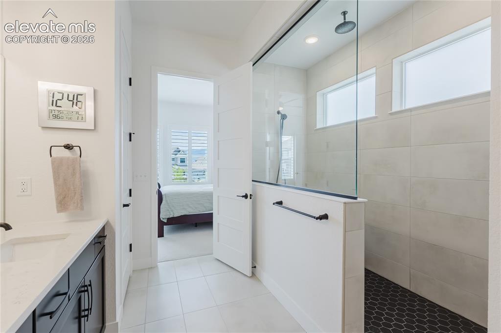 Image 29 of 46: Recessed ceiling lighting, white interior doors, and a staircase with dark