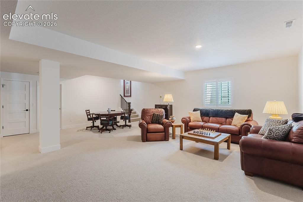 Image 33 of 46: Bedroom in the lower level with plantation shutters and a walk in closet