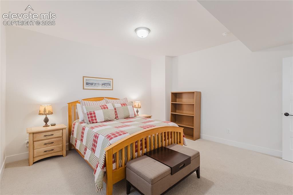 Image 42 of 46: Rear exterior featuring a spacious deck with white railings and stairs, ext