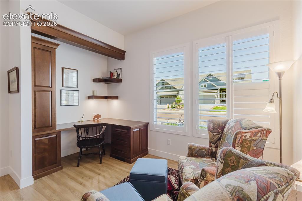 Image 7 of 46: Custom built-in bookcases with a rolling ladder, coffered ceiling with a ce