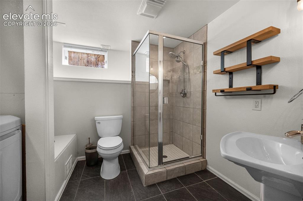 Image 37 of 48: Bathroom lower level with washer and dryer