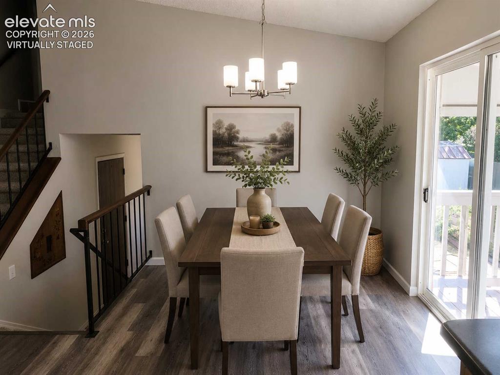 Image 5 of 17: Dining area featuring wood-finish flooring, a contemporary chandelier, and