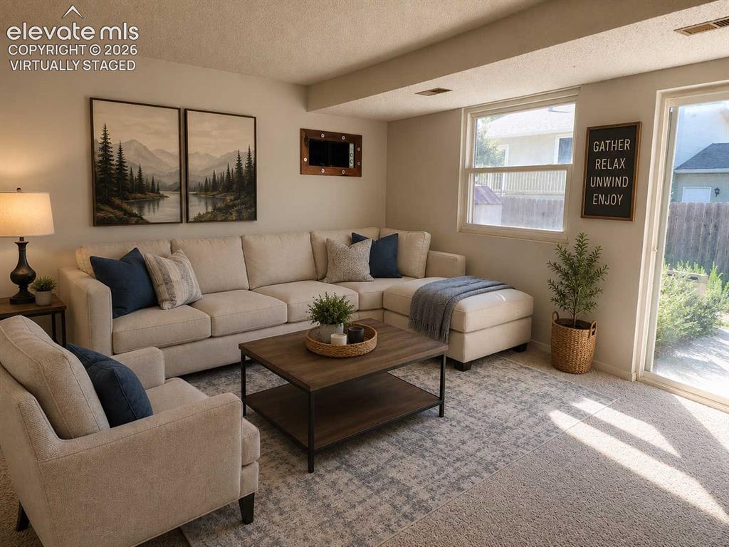 Image 9 of 17: Carpeted family room featuring a large window and sliding glass door - virt