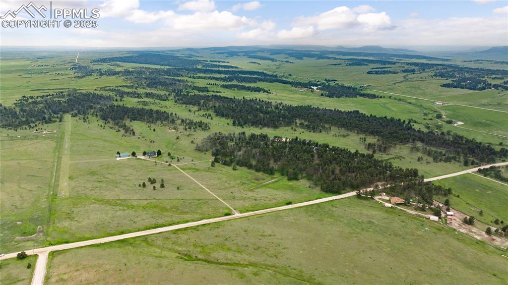Image 12 of 41: Aerial view of property and surrounding area with rural landscape, a mounta