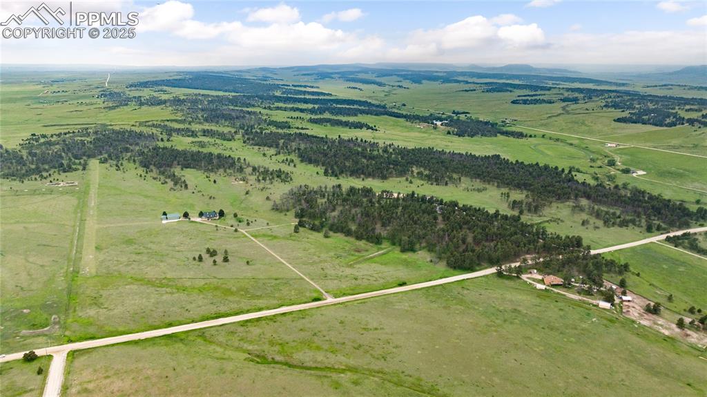 Image 13 of 41: Aerial view of property and surrounding area featuring rural landscape and 