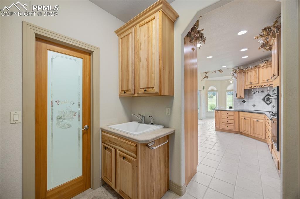 Image 22 of 41: Washroom featuring light tile patterned flooring and recessed lighting